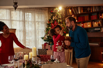 Merry Christmas! Happy family are having dinner at home.