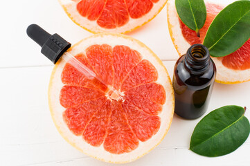 top view of juicy grapefruit with grapefruit cosmetic oil pipette. rejuvenating serum.skin care.