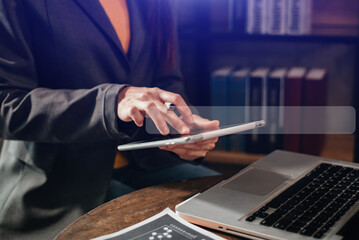 Female businessman clicking internet search page on computer and tablet touch screen at home office.