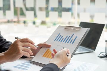 Business leaders talk about charts, financial graphs showing results are analyzing and calculating planning strategies, business success building processes