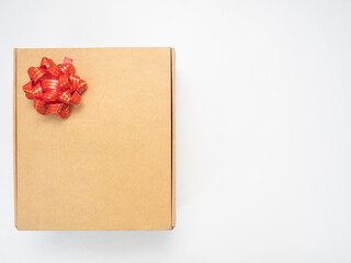 Gift box red ribbon on white table top view copy space