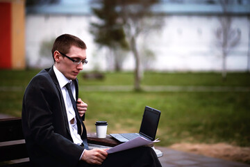 A man in a suit lies on a brick floor