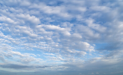 Fototapeta premium Beautiful view of sky with clouds at sunrise. Partly cloudy. Colorful sunset. Natural sky background texture, beautiful color.