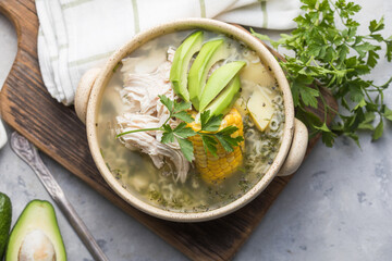 Traditional Ajiaco Colombiano - Colombian Soup with potato, chicken, avocado
