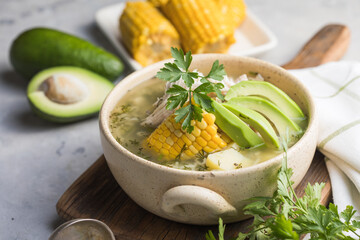 Traditional Ajiaco Colombiano - Colombian Soup with potato, chicken, avocado
