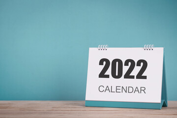Desk calendar for new year 2022 on table with copy space