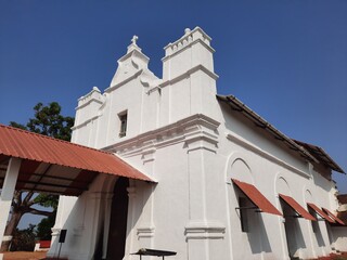 Three Kings church in goa, goa church, white color Portuguese church in Goa. blue background with...