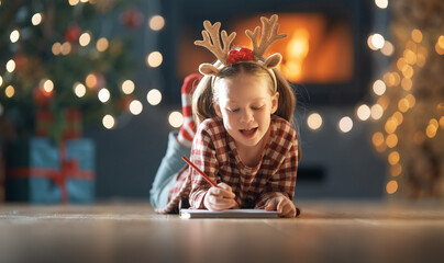 girl is writing the letter to Santa