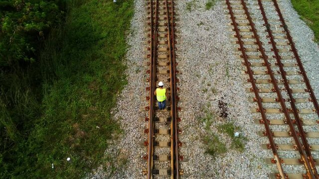 Arial view photo show engineer under inspection and checking construction process railway switch and checking work on railroad station .Engineer wearing safety uniform and safety helmet in 