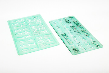 Alphabet stencils isolated on white background with selective focus