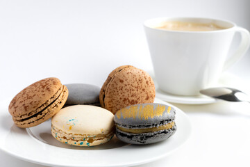 macaroons cake with a cup of coffee on a light background. close-up