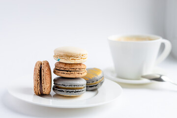 macaroons cake with a cup of coffee on a light background.