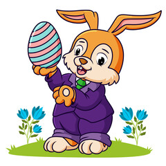 The cute rabbit is holding the easter egg
