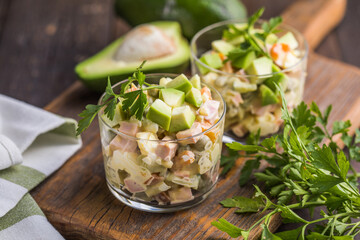 Russian traditional salad Olivier with vegetables in glasses. Winter Christmas salad