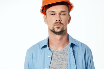 male builder in a blue shirt emotions professional studio posing