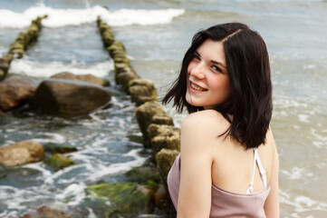 portrait of a young beautiful woman by the sea