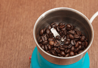 coffee beans in an electric coffee grinder