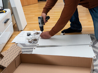 A worker assembles new furniture.