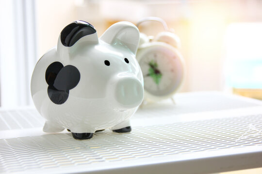 piggy bank black and white color with blur alarm colck
