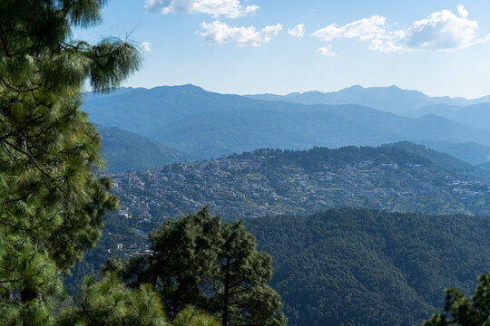 view of almora city from kesar devi on a bright sunny day