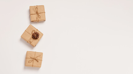 Obraz premium Festive background mockup for Christmas or New Year copy space. Gifts in paper eco-friendly packaging white background