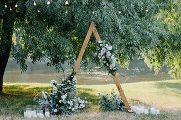 triangular wedding arch with white flowers