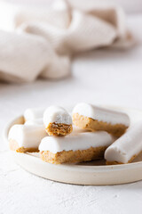 Raw carrot cake with coconut cream in a plate. Sugar, gluten and lactose free, vegan.