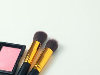 black gold makeup brush with blusher pallet om white background