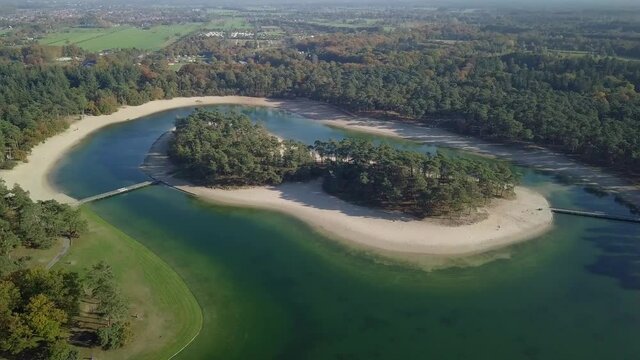 Aerial drone view of the beautiful recreational lake of the Henschotermeer in the Netherlands, Europe. Tropical paradise lake in the Netherlands drone shot.