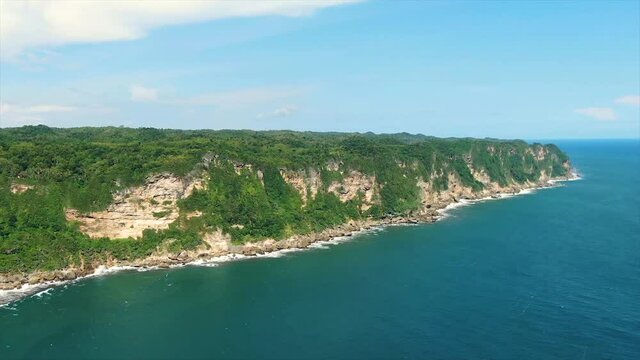 Majestic coastline cliffs in Indonesia, Parangtritis beach, aerial drone view