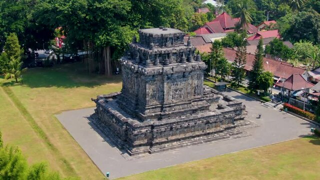 Majestic historical stone building of Mendut temple, aerial orbit view