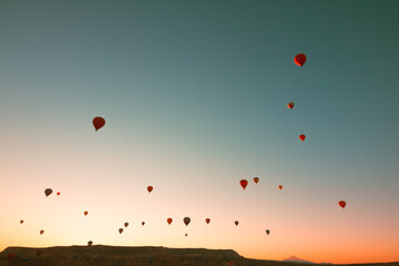 Hot air balloons at sunrise. Sunrise in Cappadocia with hot air balloons on sky