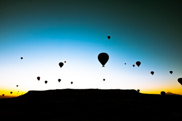 Hot air balloons silhouette. Cappadocia hot air balloons at sunrise on the sky.