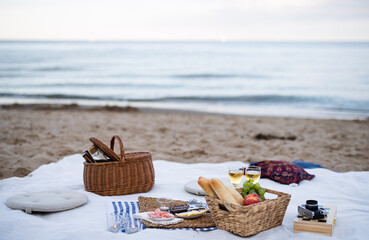 Beach picnic with schripms, beer, fruit and candles