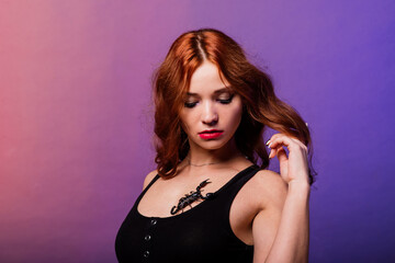 Beautiful seductive fashion redhead female with make up with a scorpion in studio