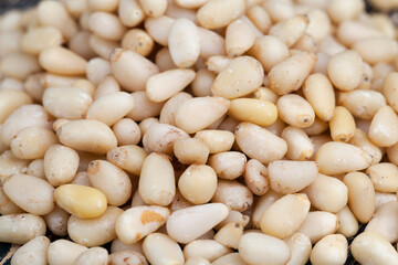 a large number of pine nuts on a wooden table