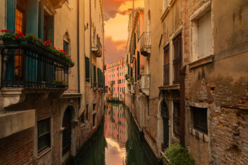 Canal with boats in Venice, Italy.