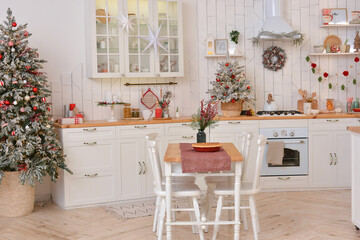 Interior of a light white сhristmas kitchen with red decor elements in the Scandinavian style. Christmas decorations. Breakfast
