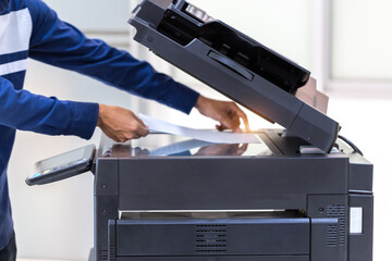 Businessman press button on panel of printer photocopier  network , Working on photocopies in the...