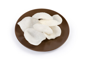Prepared rice chips on brown dish on a white background