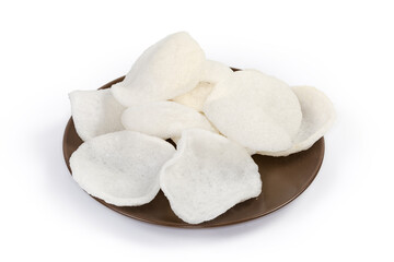 Pile of rice chips on brown dish on white background
