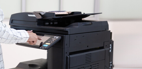 Bussinessman press button on panel of printer photocopier  network , Working on photocopies in the office concept , printer is office worker tool equipment for scanning and copy paper.