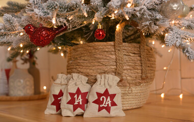 Fototapeta na wymiar Advent calendar. Christmas bags with gifts on the background of a Christmas tree ,golden bokeh.Christmas background.Christmas mood