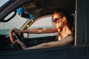 Obraz na płótnie Canvas woman driving in car trip posing fashion travel