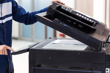 Businessman press button on panel of printer photocopier  network , Working on photocopies in the office concept , printer is office worker tool equipment for scanning and copy paper.