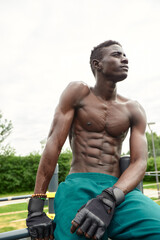 African man smiling after workout. He is in a park.