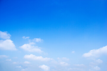 Naklejka na ściany i meble Blue sky background and white clouds soft focus, and copy space horizontal shape.