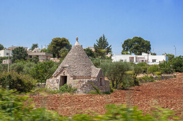Fototapeta na wymiar white traditional southern italian trulli village houses with tapered stone roofs