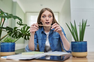 Positive smiling female university student talking looking at webcam, at home.
