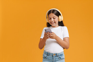 White brunette girl listening music with cellphone and headphones